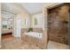 Bathroom features a built-in bathtub, tiled shower, and a view into the main bedroom at 4875 Churchill Ridge Dr, Cumming, GA 30028