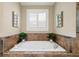Bathroom features a large soaking tub with tile surround, perfect for relaxation and comfort at 4875 Churchill Ridge Dr, Cumming, GA 30028
