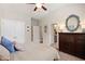 Bedroom featuring a ceiling fan, dresser, and closet at 4875 Churchill Ridge Dr, Cumming, GA 30028