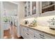Well-appointed butler's pantry with custom cabinetry, granite countertops, and modern appliances at 4875 Churchill Ridge Dr, Cumming, GA 30028