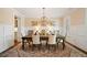Elegant dining room featuring wainscoting, chandelier, and stylish decor at 4875 Churchill Ridge Dr, Cumming, GA 30028