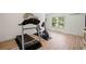Bright exercise room with a window, wood floors, treadmill and stationary bike at 4875 Churchill Ridge Dr, Cumming, GA 30028