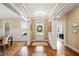 Open foyer with hardwood floors, white trim, and a clear view to the front door at 4875 Churchill Ridge Dr, Cumming, GA 30028