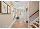 Inviting foyer with tile floors, bench, and decoratively framed artwork at 4875 Churchill Ridge Dr, Cumming, GA 30028