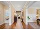 Long hallway with hardwood floors, white trim, and lots of natural light from the windows at 4875 Churchill Ridge Dr, Cumming, GA 30028