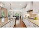 Gourmet kitchen features stainless steel appliances, granite countertops, and a view into the dining area at 4875 Churchill Ridge Dr, Cumming, GA 30028