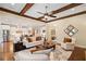 Bright living room with hardwood floors, ceiling fan, and an open view to the kitchen at 4875 Churchill Ridge Dr, Cumming, GA 30028