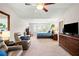 Spacious main bedroom with ceiling fan, carpeted floors, large window and flat screen tv at 4875 Churchill Ridge Dr, Cumming, GA 30028