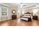 Main bedroom with tray ceilings, hardwood floors, and a sitting area with a view of the backyard at 4875 Churchill Ridge Dr, Cumming, GA 30028