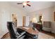 Another view of office with custom built-in shelves, desk, and hardwood floors at 4875 Churchill Ridge Dr, Cumming, GA 30028