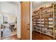 Walk-in pantry with custom wood shelving and a rustic sliding door, adjacent to dining area at 4875 Churchill Ridge Dr, Cumming, GA 30028