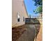 Backyard of the home with a view of the side yard and partial fencing at 5022 Anclote Dr, Alpharetta, GA 30022
