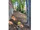 View of fenced backyard with wooded area and sloped hillside at 5022 Anclote Dr, Alpharetta, GA 30022