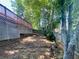 Backyard view of deck, privacy fence, and natural setting at 5022 Anclote Dr, Alpharetta, GA 30022