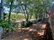 Backyard with tall trees and partially fenced in yard at 5022 Anclote Dr, Alpharetta, GA 30022