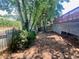 View of fenced backyard featuring a wooded area, offering privacy and a natural setting at 5022 Anclote Dr, Alpharetta, GA 30022