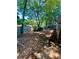 Backyard with tall trees and partially fenced in yard at 5022 Anclote Dr, Alpharetta, GA 30022