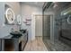 Modern bathroom with double sink vanity and walk-in glass shower with unique tile work at 5022 Anclote Dr, Alpharetta, GA 30022