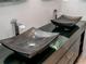 Close up of vessel sinks and unique faucet fixtures in a modern bathroom at 5022 Anclote Dr, Alpharetta, GA 30022