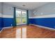 Unique bedroom featuring hardwood floors, blue and grey walls with space themed art, and a window with curtains at 5022 Anclote Dr, Alpharetta, GA 30022