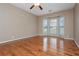 Spacious bedroom with hardwood floors, a ceiling fan, and a bay window offering ample natural light at 5022 Anclote Dr, Alpharetta, GA 30022
