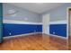 Space themed bedroom with hardwood floors, a white door, and window with light-blocking curtains at 5022 Anclote Dr, Alpharetta, GA 30022