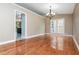 Formal dining room featuring hardwood floors and a stylish chandelier fixture at 5022 Anclote Dr, Alpharetta, GA 30022