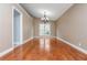 Formal dining room featuring hardwood floors and a modern chandelier at 5022 Anclote Dr, Alpharetta, GA 30022