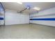 Spacious garage featuring an epoxy floor, painted walls, and an automatic garage door opener at 5022 Anclote Dr, Alpharetta, GA 30022