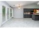 Spacious kitchen with grey cabinets, granite countertop island, and access to the outdoor deck at 5022 Anclote Dr, Alpharetta, GA 30022
