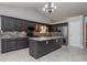 Modern kitchen with stainless steel appliances, grey cabinets, grey backsplash and a granite countertop island at 5022 Anclote Dr, Alpharetta, GA 30022