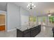 Spacious kitchen with grey cabinets, granite countertop island, and access to the outdoor deck at 5022 Anclote Dr, Alpharetta, GA 30022