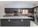 Modern kitchen with stainless steel appliances, grey cabinets, grey backsplash and a granite countertop island at 5022 Anclote Dr, Alpharetta, GA 30022