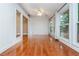 Living room with wood floors, access to the outdoor deck and multiple windows at 5022 Anclote Dr, Alpharetta, GA 30022
