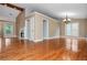 Spacious living room featuring hardwood floors, fireplace, and a large window at 5022 Anclote Dr, Alpharetta, GA 30022