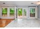Living room with tile floors, access to the outdoor deck and multiple windows at 5022 Anclote Dr, Alpharetta, GA 30022