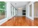 Living room with wood floors, access to the outdoor deck and multiple windows at 5022 Anclote Dr, Alpharetta, GA 30022