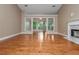 Spacious living room with hardwood floors and fireplace, flowing with natural light at 5022 Anclote Dr, Alpharetta, GA 30022