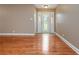 Spacious living room featuring hardwood floors and a front door with glass panel at 5022 Anclote Dr, Alpharetta, GA 30022