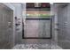 Walk-in shower with gray tiling, black accents, and multi-spray head at 5022 Anclote Dr, Alpharetta, GA 30022