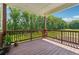 Spacious wooden deck overlooking a private, wooded backyard with lush greenery at 5545 Adirondack Dr, Cumming, GA 30040