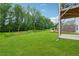 Lush green backyard with a gentle slope and mature trees surrounding the property at 5545 Adirondack Dr, Cumming, GA 30040