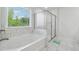 Bright bathroom with a soaking tub, separate glass shower, and a view of the outdoors at 5545 Adirondack Dr, Cumming, GA 30040