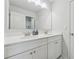 Bathroom with double sinks, white cabinets, a large mirror, and modern fixtures at 5545 Adirondack Dr, Cumming, GA 30040