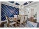 Formal dining room featuring stylish decor, a modern chandelier, and a designer accent wall at 5545 Adirondack Dr, Cumming, GA 30040