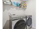 Laundry room featuring a modern washer and dryer with stylish tile flooring and shelf at 5545 Adirondack Dr, Cumming, GA 30040
