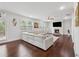 Bright living room featuring hardwood floors, a large sectional sofa and a fireplace with flat screen tv at 5545 Adirondack Dr, Cumming, GA 30040