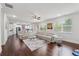 Bright living room seamlessly connects to the kitchen and features hardwood floors and a large sectional sofa at 5545 Adirondack Dr, Cumming, GA 30040