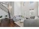 Inviting living room showcasing a staircase, hardwood floors, and a contemporary design at 5545 Adirondack Dr, Cumming, GA 30040