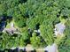 Aerial view of property featuring a pool and surrounding trees at 686 Hillwood Ct, Dacula, GA 30019